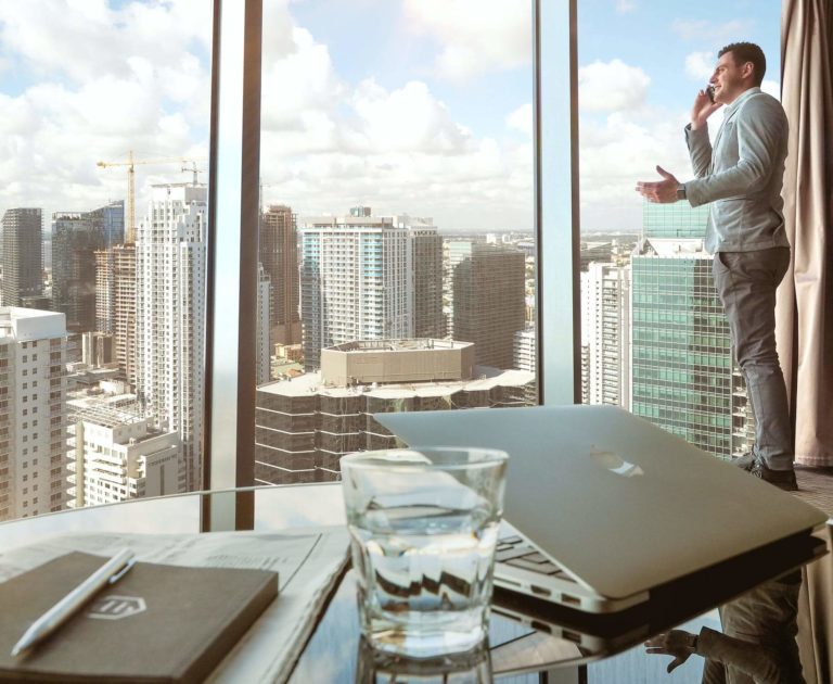 a person standing on a balcony overlooking a city