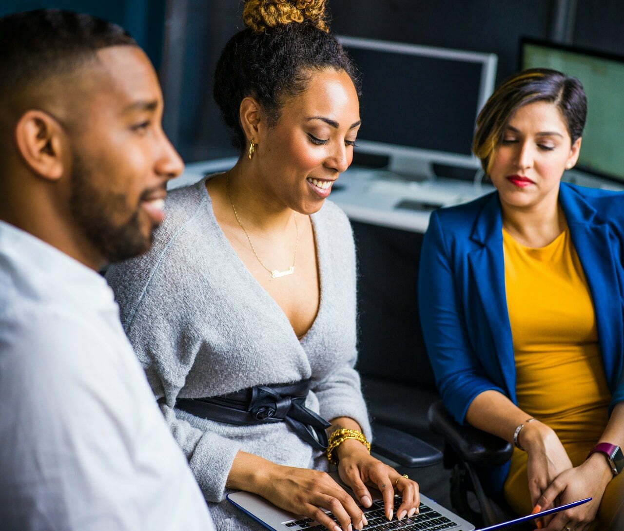 a group of people looking at a computer screen