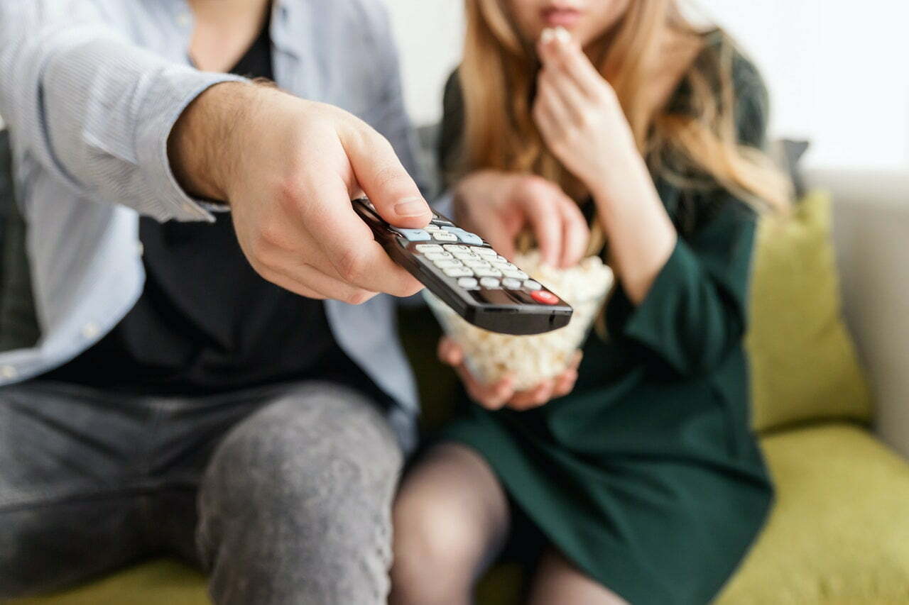 a group of people sitting on a couch holding a cell phone