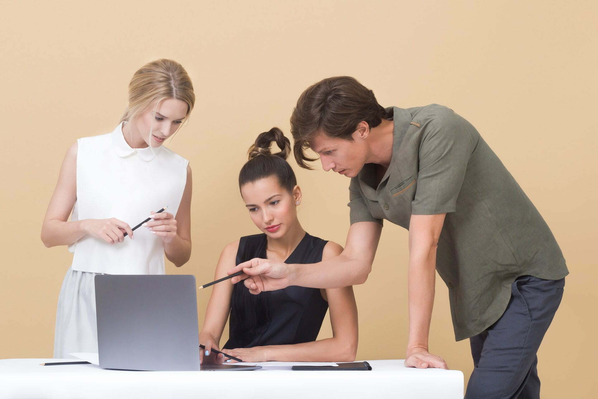 a group of people looking at a computer screen