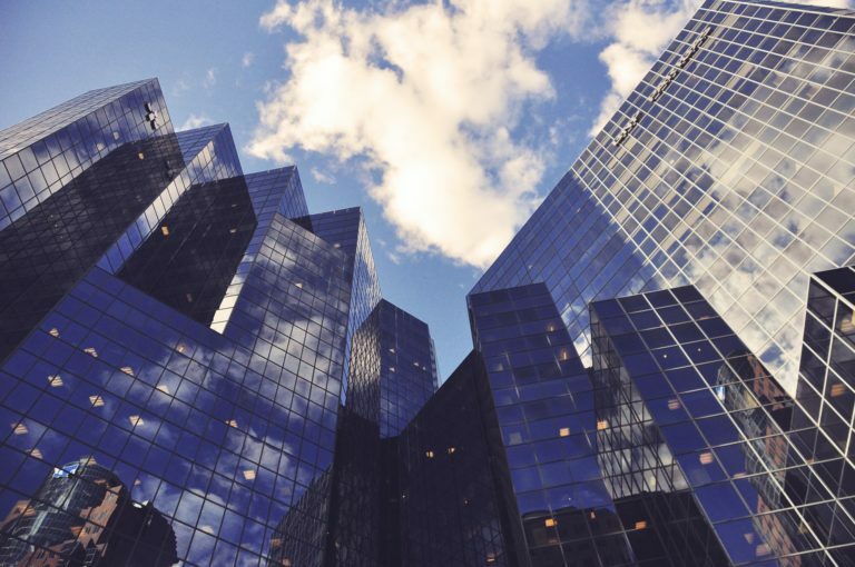 a group of skyscrapers with smoke coming out of them