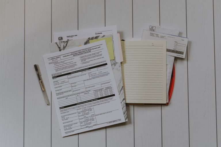 a white board with papers on it