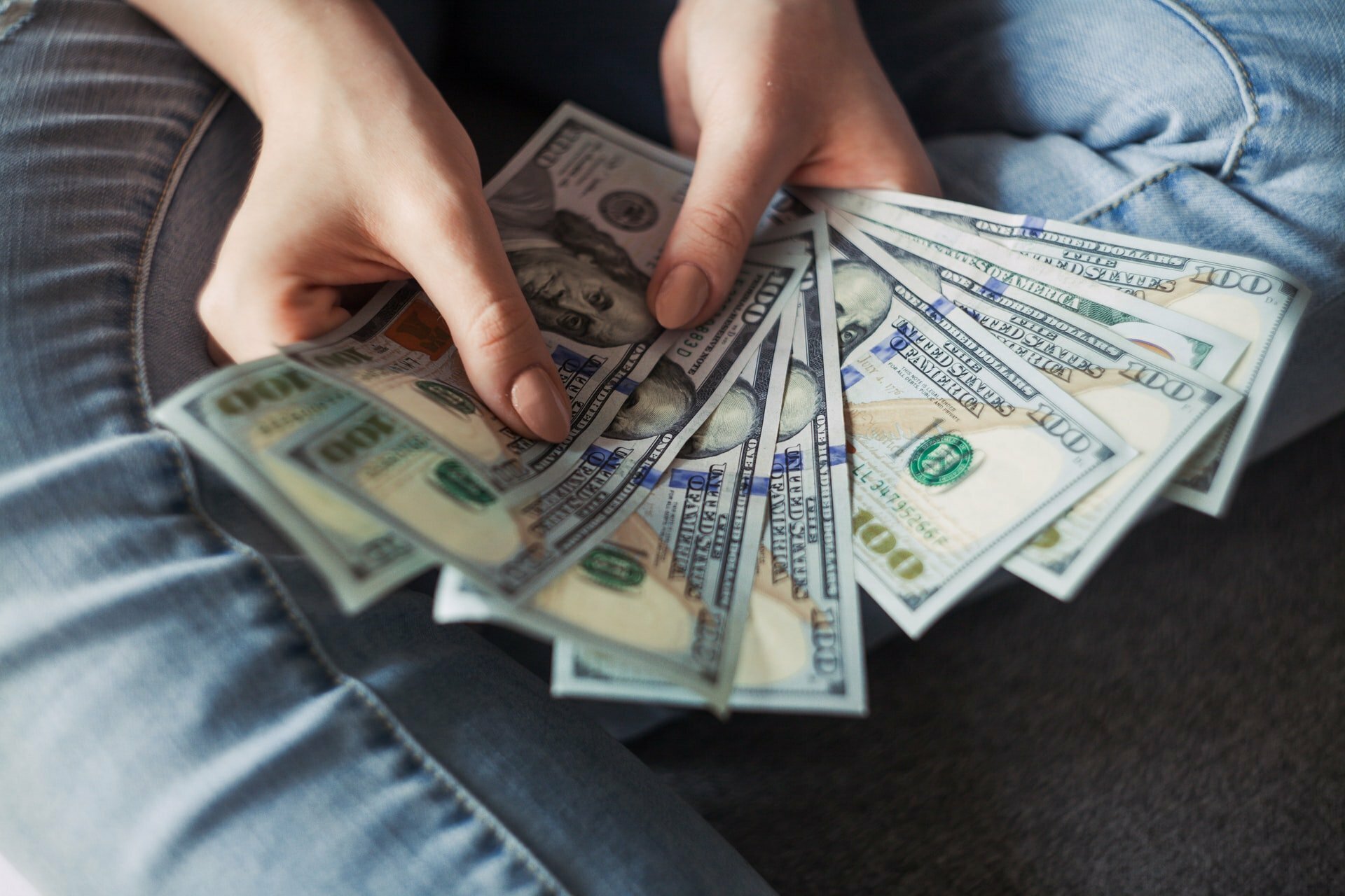 a person holding bundles of paper money