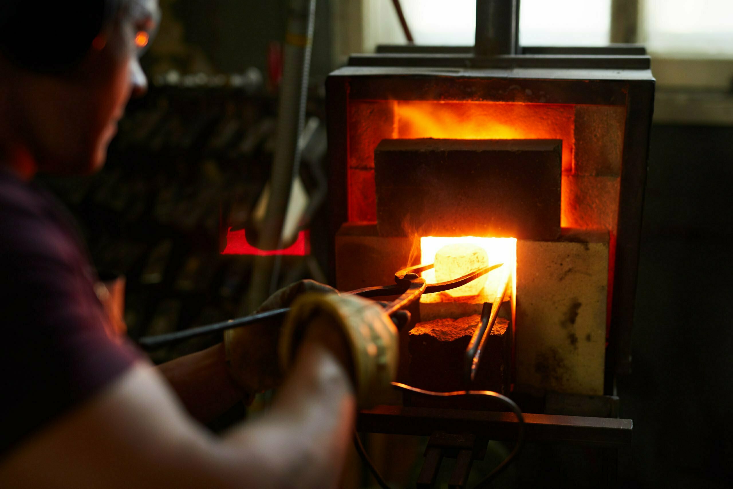 a man holding a wood burning stove