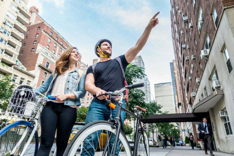 a man and woman riding bikes