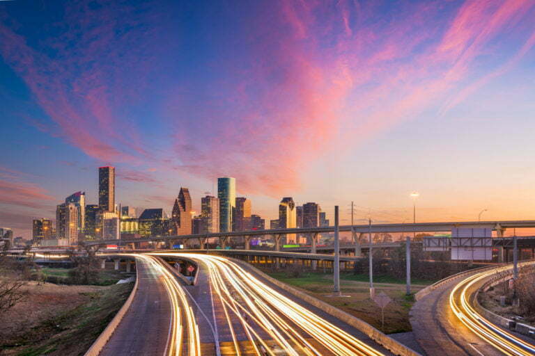 a road with a city in the background