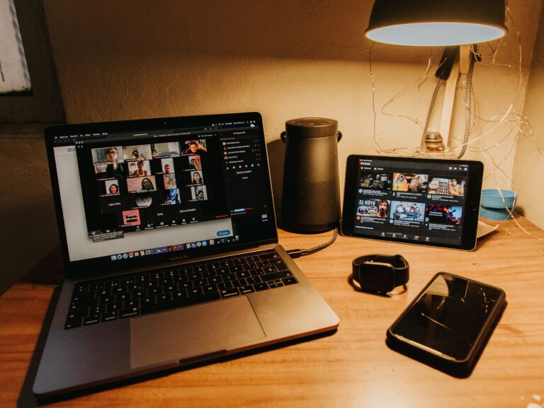 a laptop and cell phones on a desk